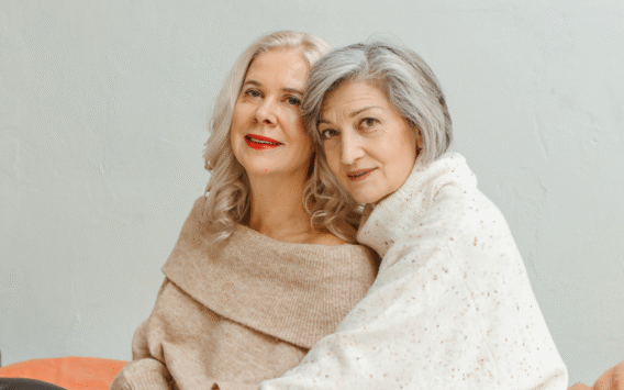 Image showing two women over 60 symbolizing the link between gut health and dementia, with icons for probiotics, leafy greens, and memory.